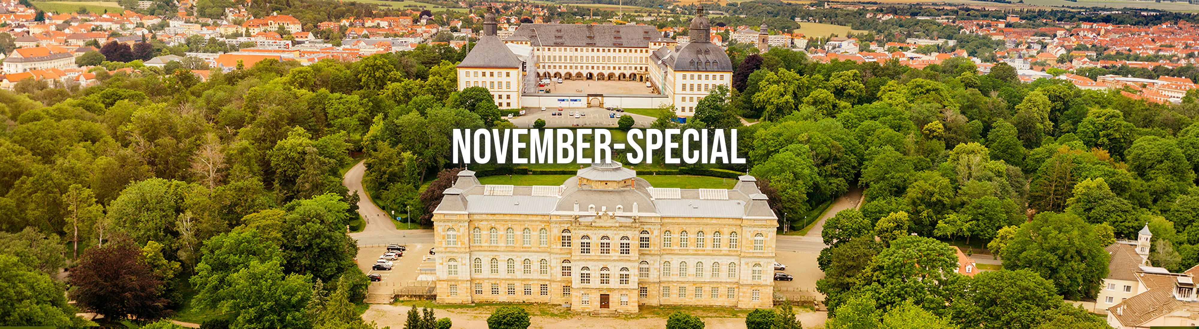 Schloss im barocken Stil mit zwei großen Kuppeltürmen, umgeben von gepflegten Gärten.