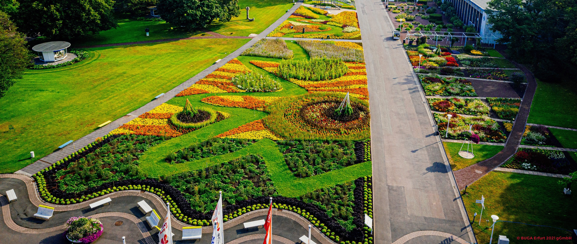 Blühender Park mit Tulpen, Springbrunnen und historischem Gebäude im Hintergrund.